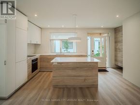 Pelham (Fonthill) townhouse for rent - A modern kitchen with wooden floors and white cabinets.