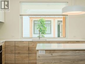 Pelham (Fonthill) townhouse for rent - A modern kitchen with wooden cabinets and a large window.