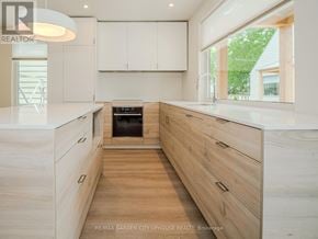 Pelham (Fonthill) townhouse for rent - A modern kitchen with wooden cabinets and drawers.