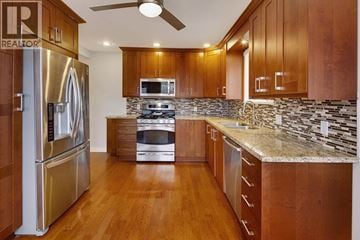 Burnaby apartment for rent - A kitchen with wooden cabinets and a stainless steel refrigerator.