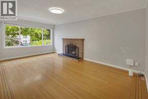 Burnaby apartment for rent - A room with a fireplace and a large window.
