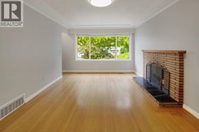 Burnaby apartment for rent - A large, empty room with a fireplace and a window.