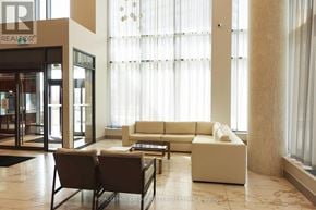 Toronto (Henry Farm) condo for rent - A living room with a white sofa and a glass door.