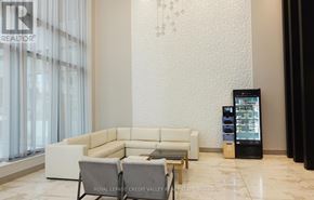 Toronto (Henry Farm) condo for rent - A white sofa set in a room with a vending machine.
