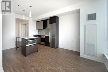 Toronto (Kensington-Chinatown) condo for rent - A modern kitchen with dark wood floors and white walls.
