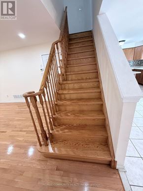 Toronto (Rouge) apartment for rent - A wooden staircase with a white railing.