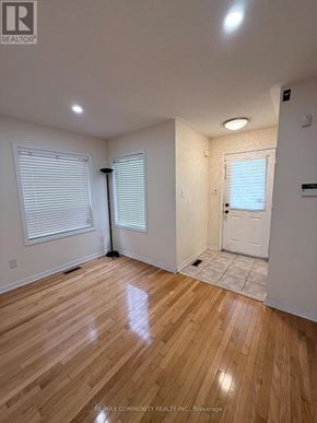 Toronto (Rouge) apartment for rent - A room with wooden flooring and white walls.