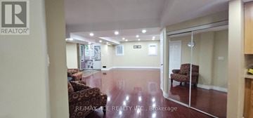 Toronto (Highland Creek) apartment for rent - A living room with a couch and a chair in it.
