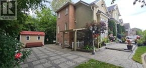 Toronto (Highland Creek) apartment for rent - A house with a red roof is surrounded by greenery.