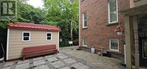 Toronto (Highland Creek) apartment for rent - A small house with a red roof and a bench in front of it.
