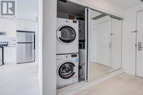 Markham (Wismer) condo for rent - A modern laundry room with a washer and dryer built into the wall.