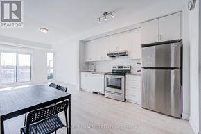 Markham (Wismer) condo for rent - A kitchen with a table and chairs in front of a window.