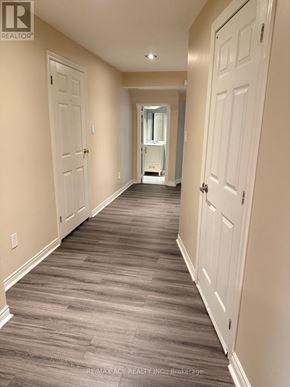 Toronto (Rouge) apartment for rent - A hallway with wood flooring and white doors.