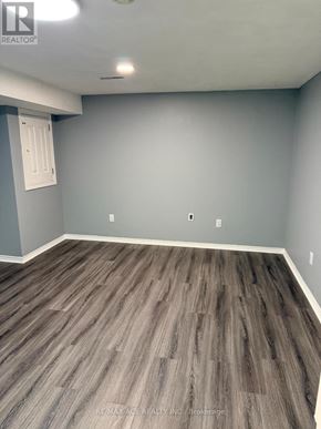 Toronto (Rouge) apartment for rent - A room with grey walls and wooden flooring.