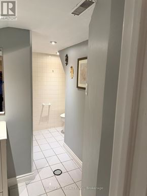 Toronto (Rouge) apartment for rent - A bathroom with a toilet, sink, and a picture on the wall.