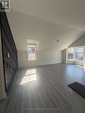 Whitchurch-Stouffville (Stouffville) apartment for rent - A spacious room with wooden flooring and a skylight.