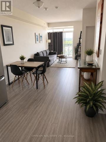 Waterloo condo for rent - A living room with a dining table and chairs.