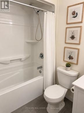 Waterloo condo for rent - A white toilet in a bathroom with a white tub and shower curtain.