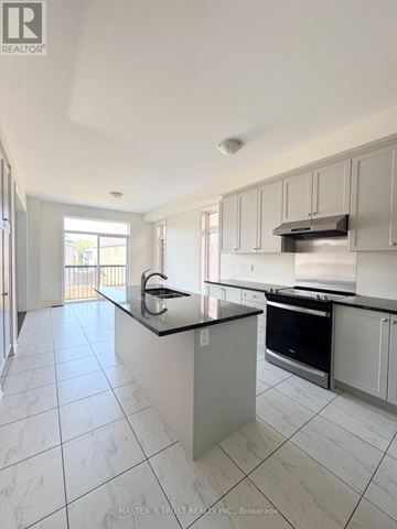 East Gwillimbury (Holland Landing) apartment for rent - A kitchen with white cabinets and a black counter top.