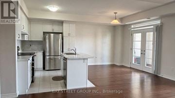 Markham (Box Grove) townhouse for rent - A kitchen with white cabinets and a refrigerator.