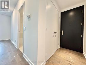 Toronto (Kensington-Chinatown) condo for rent - A room with a black door and a white door.