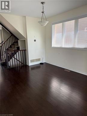 Cambridge apartment for rent - A room with wooden floors and a staircase.