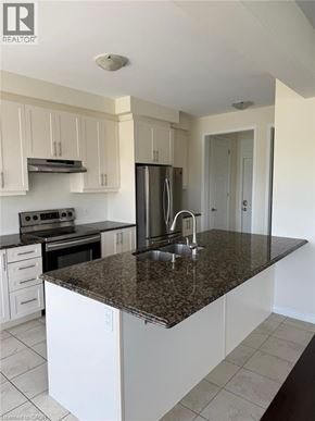 Cambridge apartment for rent - A kitchen with white cabinets and a granite countertop.