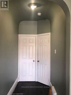 Toronto (Dufferin Grove) multi-family for rent - A white door in a room with a grey wall.