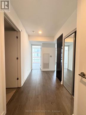 Toronto (Church-Yonge Corridor) condo for rent - A hallway with wood flooring and white walls.