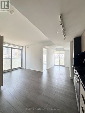 Toronto (Church-Yonge Corridor) condo for rent - A spacious room with a grey floor and white walls.