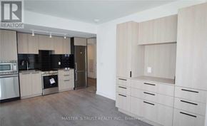 Toronto (Church-Yonge Corridor) condo for rent - A kitchen with wooden cabinets and a refrigerator.