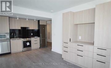 Toronto (Church-Yonge Corridor) condo for rent - A kitchen with wooden cabinets and a refrigerator.