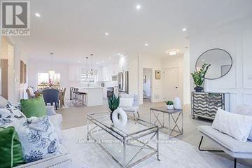 Georgina (Pefferlaw) apartment for rent - A living room with a glass coffee table and a white sofa.