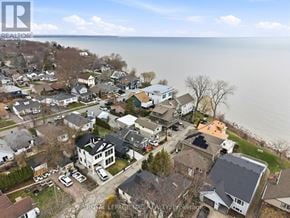 St. Catharines (Port Dalhousie) apartment for rent - A bird's eye view of a residential area with houses and a body of water in the background.