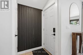 St. Catharines (Port Dalhousie) apartment for rent - A white door with a black handle is in a room with white walls.