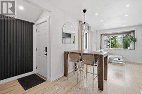 St. Catharines (Port Dalhousie) apartment for rent - A dining area with a table and chairs is shown in the image.