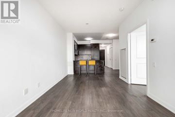 Toronto (Willowdale West) condo for rent - A spacious room with wooden flooring and white walls, featuring a kitchenette with a sink and cabinets.