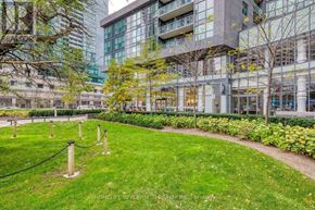 Toronto (Willowdale West) condo for rent - A grassy area with a chain barrier and a building in the background.