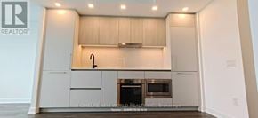 Toronto (Cabbagetown-South St. James Town) condo for rent - A modern kitchen with a stainless steel oven and a wooden cabinetry.