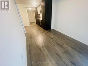 Toronto (Waterfront Communities) condo for rent - A room with wooden flooring and a white wall.