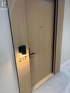 Toronto (Englemount-Lawrence) condo for rent - Door number 217 is closed and has a black handle.
