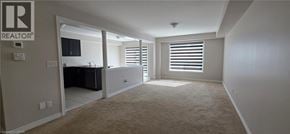 Ayr apartment for rent - A realtor logo is on the wall in a spacious room.