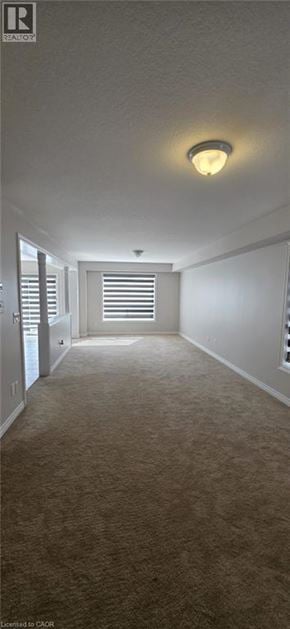 Ayr apartment for rent - A room with a carpeted floor and a light fixture on the ceiling.