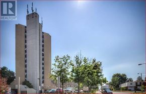 Toronto (Malvern) condo for rent - A tall building with a sign that says "REALTOR" on it.