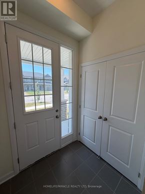Loyalist (Bath) apartment for rent - A room with white doors and a window showing a view of a building outside.