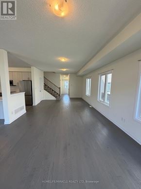 Loyalist (Bath) apartment for rent - A spacious room with wooden flooring and white walls.