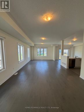 Loyalist (Bath) apartment for rent - A spacious room with wooden floors and white walls.