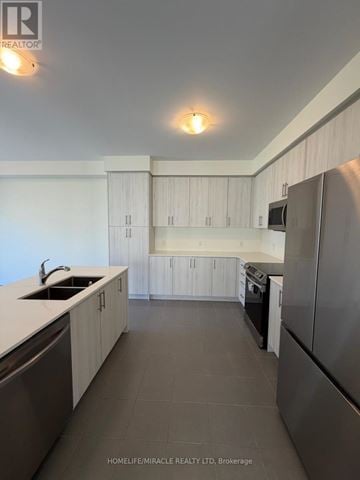 Loyalist (Bath) apartment for rent - A modern kitchen with white cabinets and a stainless steel refrigerator.