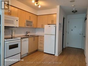 Toronto (Bendale) condo for rent - A kitchen with wooden cabinets and white appliances.