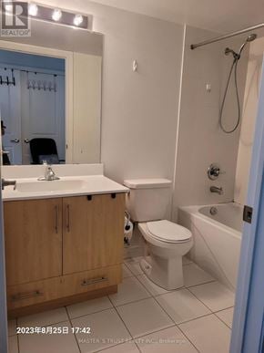 Toronto (Bendale) condo for rent - A bathroom with a toilet, sink, and mirror.